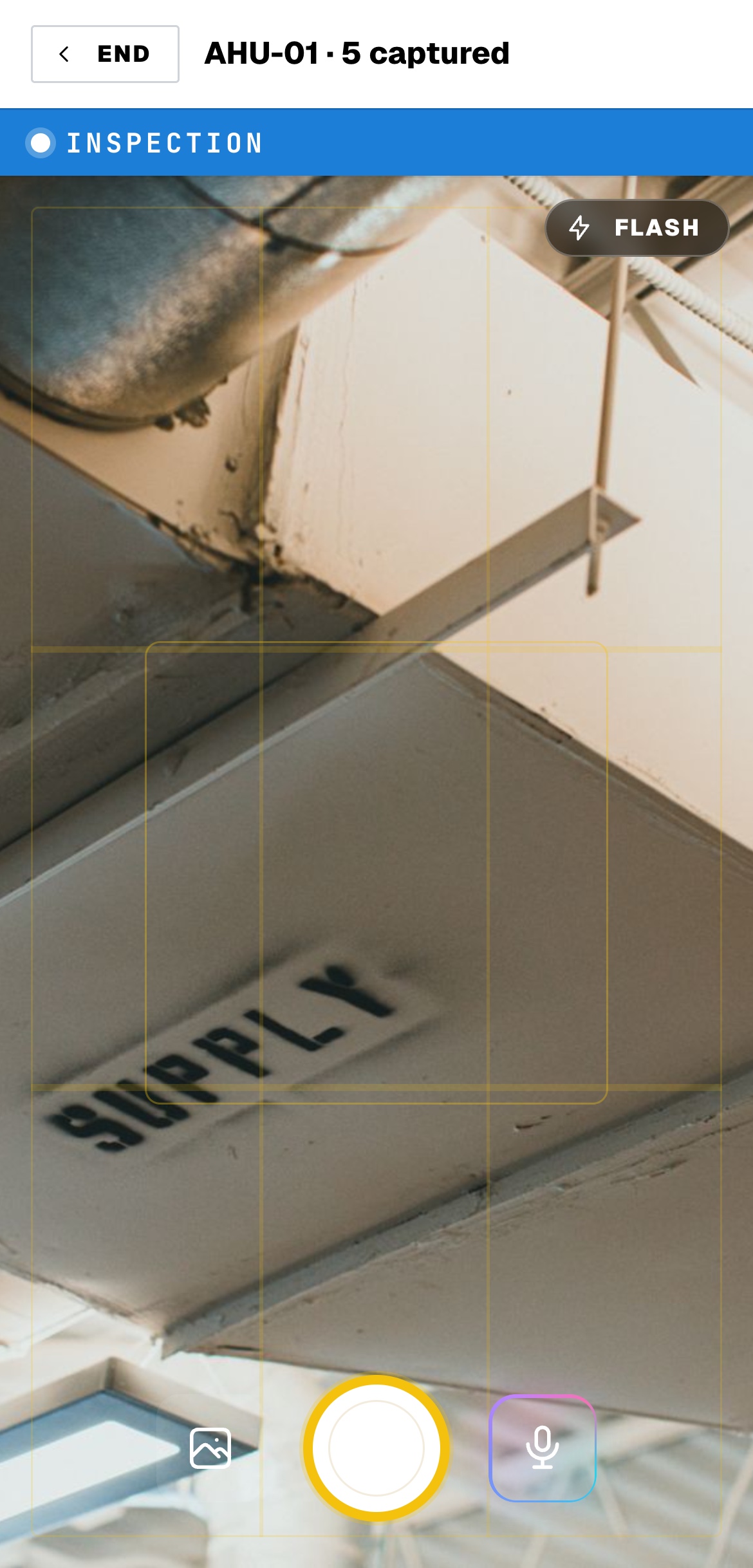 The field app camera capturing a before photo of an air handling unit coil, with the voice capture button beside the shutter.